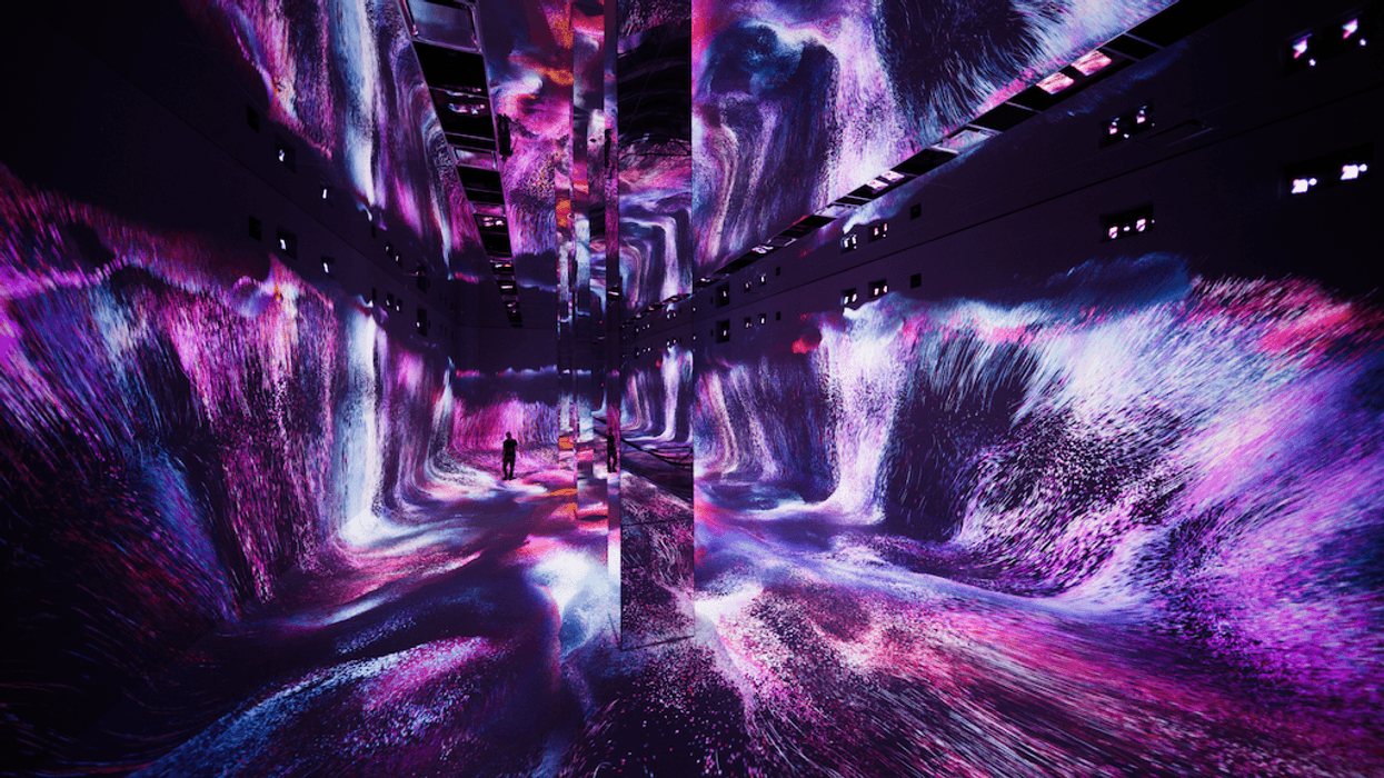 Immersive room with vibrant pink and purple digital waves and mirrored reflections.