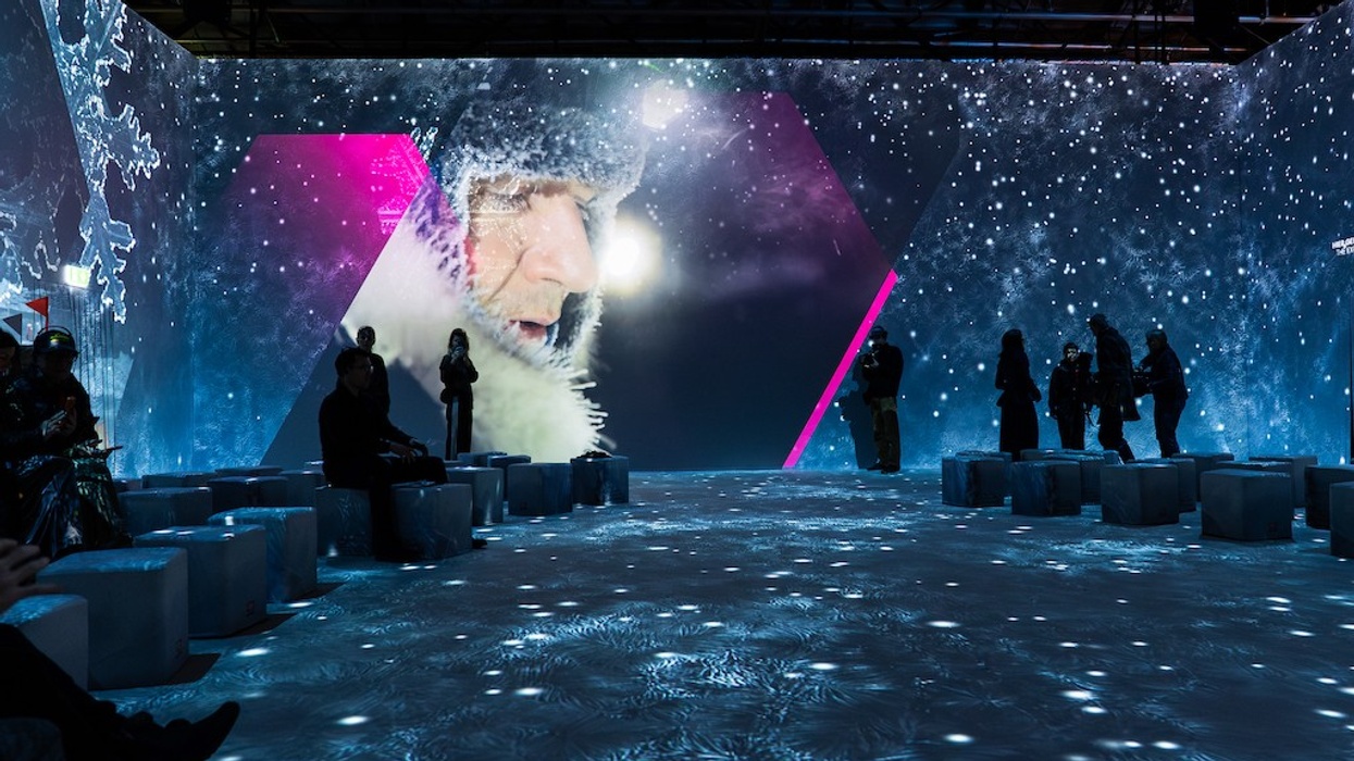 Immersive winter-themed room with projected man in fur hat and icy seats.