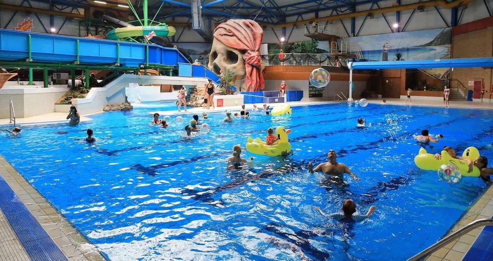 Indoor aquatic park, Calypso Cove, with swimmers, slides, and inflatable toys.
