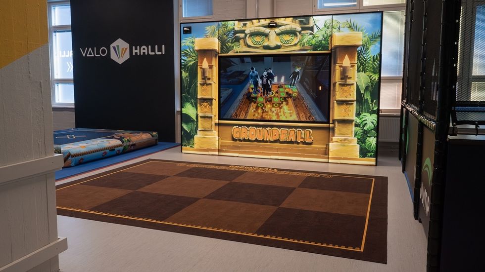 Indoor gaming area with "Groundfall" theme and vibrant decor.