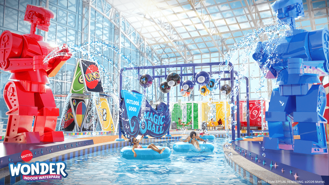 Indoor Mattel waterpark with giant toy figures, playing cards, and people in tubes.
