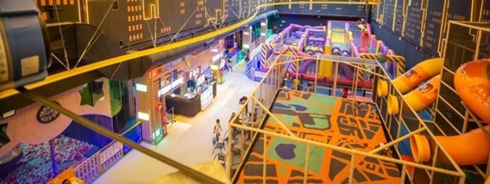 Indoor play center with colorful slides, climbing areas, and a snack bar.
