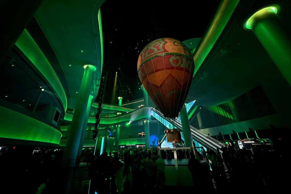 Indoor scene with a glowing green theme and a large hot air balloon display.