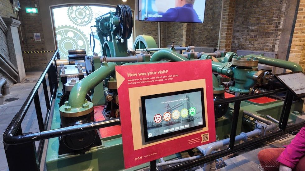 Industrial machinery display with a digital visitor feedback screen.