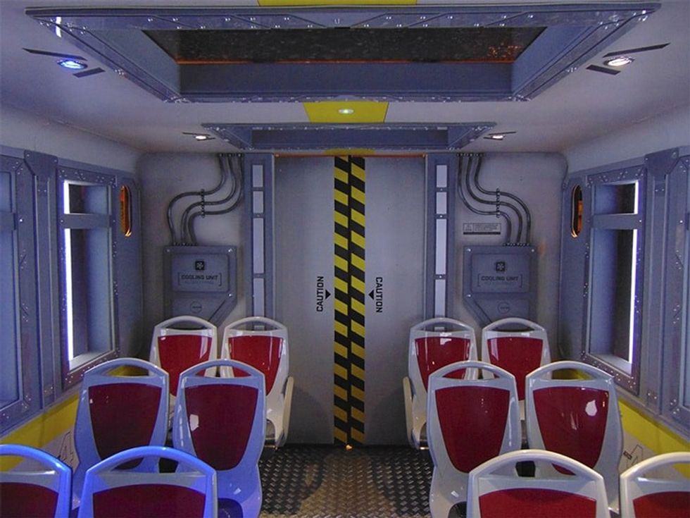 Inside Simworx Immersive Adventurer Ride with red seats and steel aesthetic