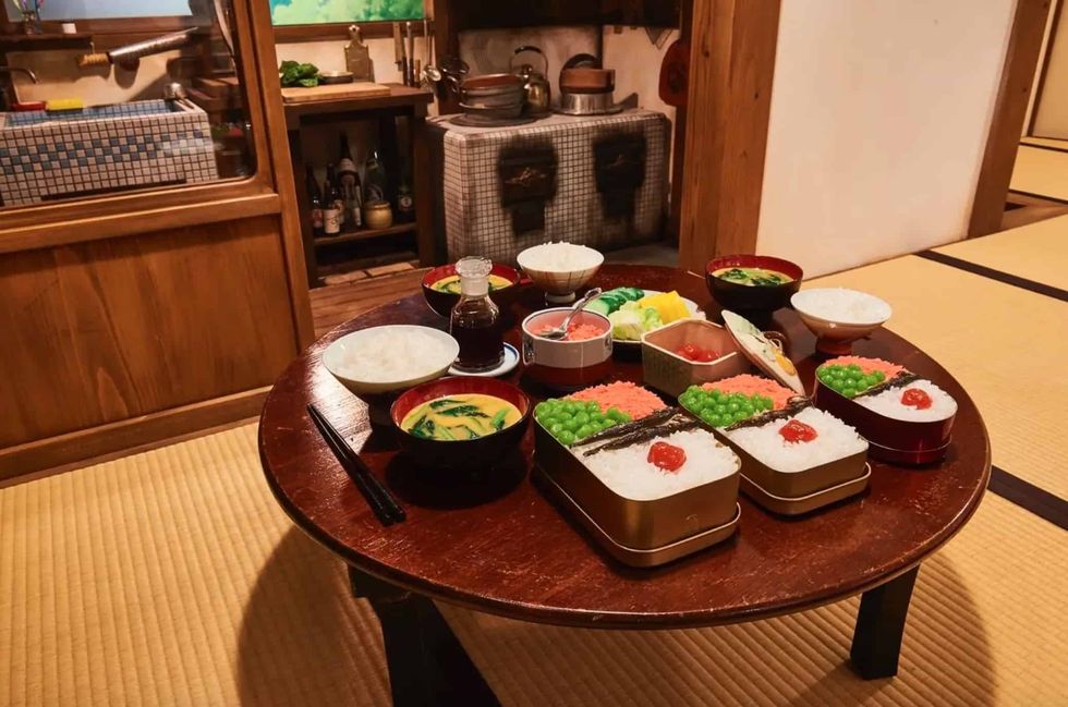 Japanese meal set on a wooden table in a traditional tatami room at Ghibli's Grand Warehouse