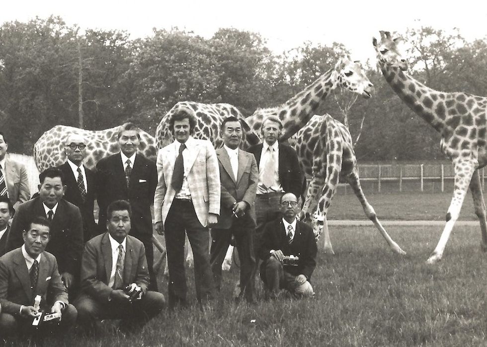 japanese visitors with giraffes
