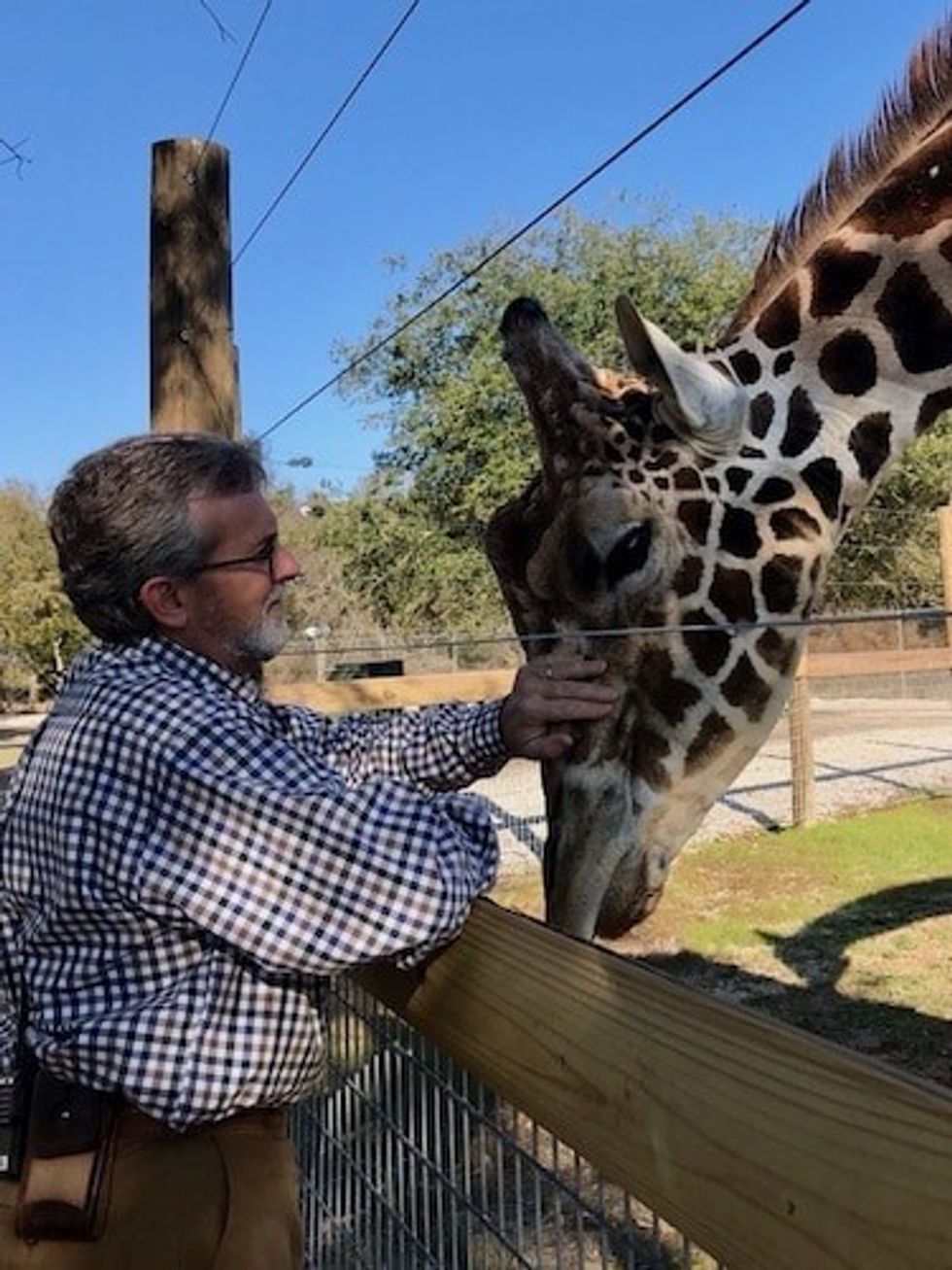 Joel Hamilton, Director of Alabama Gulf Coast Zoo, with Benjamin the giraffe
