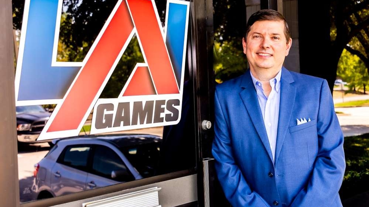 John Bugh standing in front of LAI Games sign