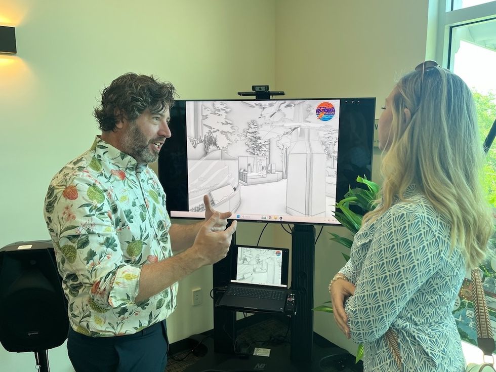 John Shaw of Museum EXP discussing a digital architectural drawing on a monitor.