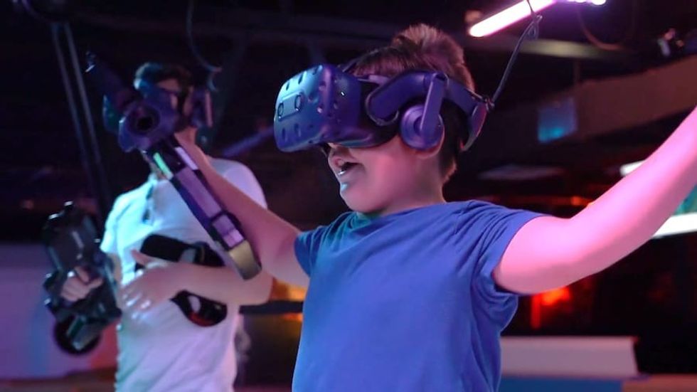 Kid playing with the Boxblaster VR attractions