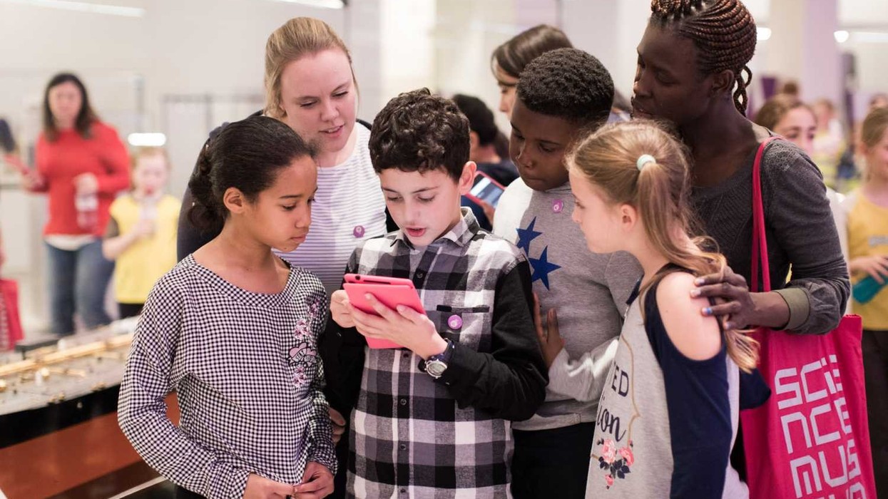 kids at science museum using aardman treasure hunters mobile tour app