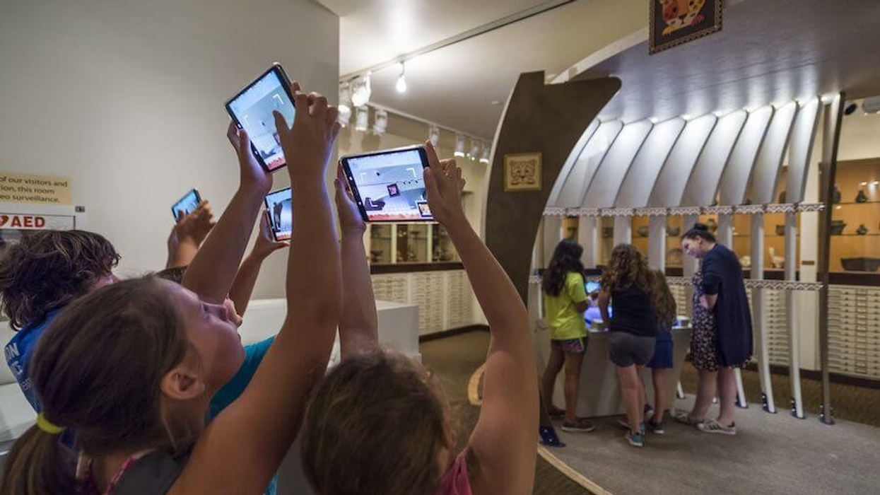 kids holding up tablets