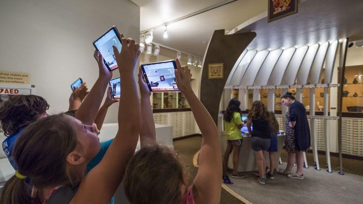 kids holding up tablets