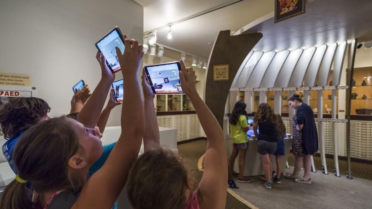 kids holding up tablets