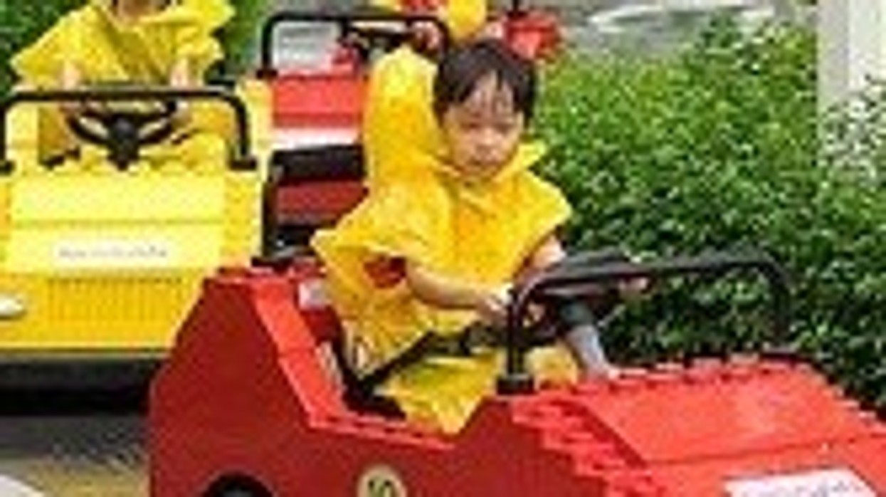 kids in train driving lego cars