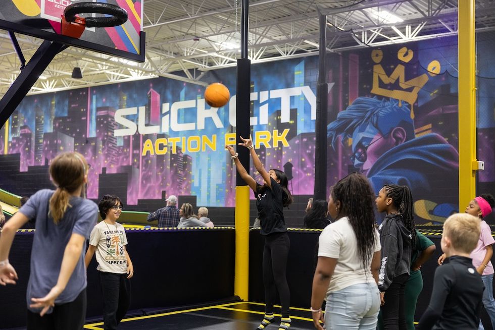 Kids play basketball indoors at Slick City Action Park.