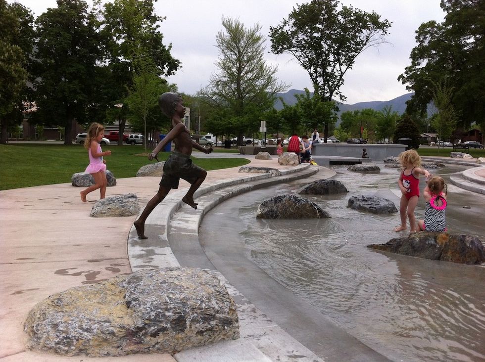 Kids play in water feature