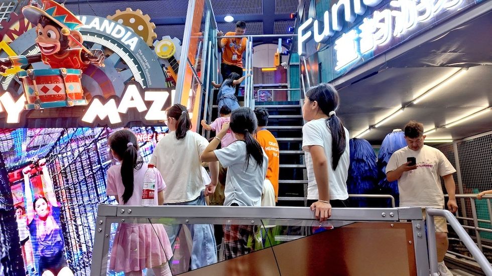 Kids waiting for a turn on PlayMaze at a trade show