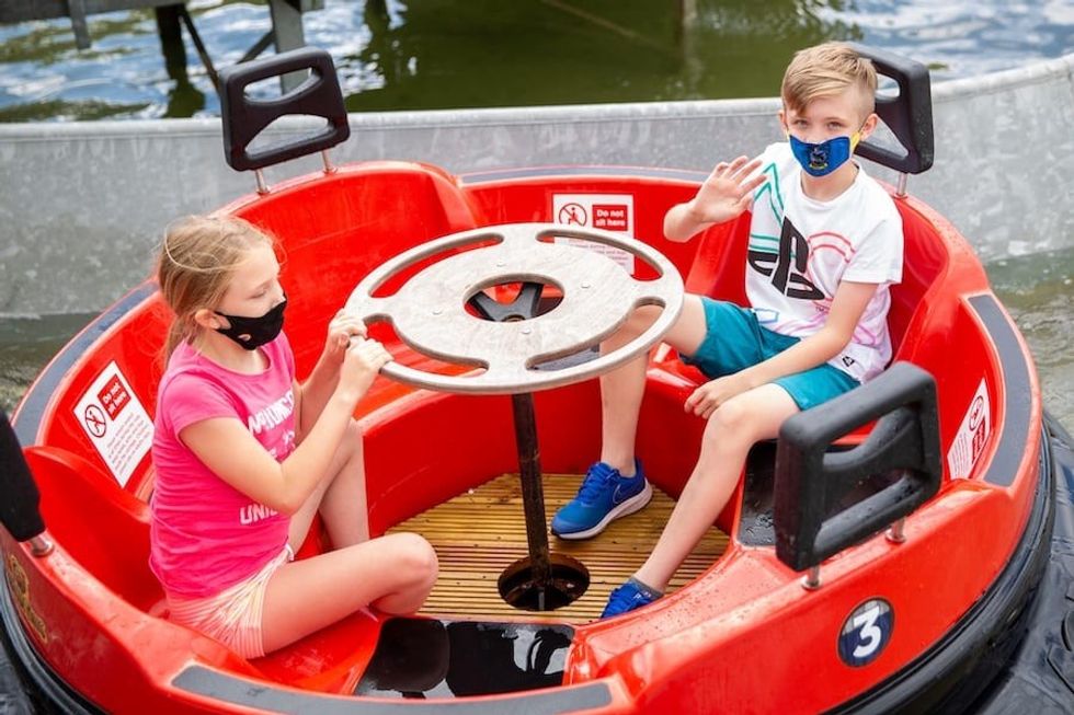 Kids wearing masks on the Apache Falls ride