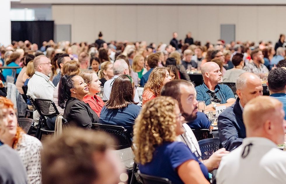 Large audience attentively seated at a conference.
