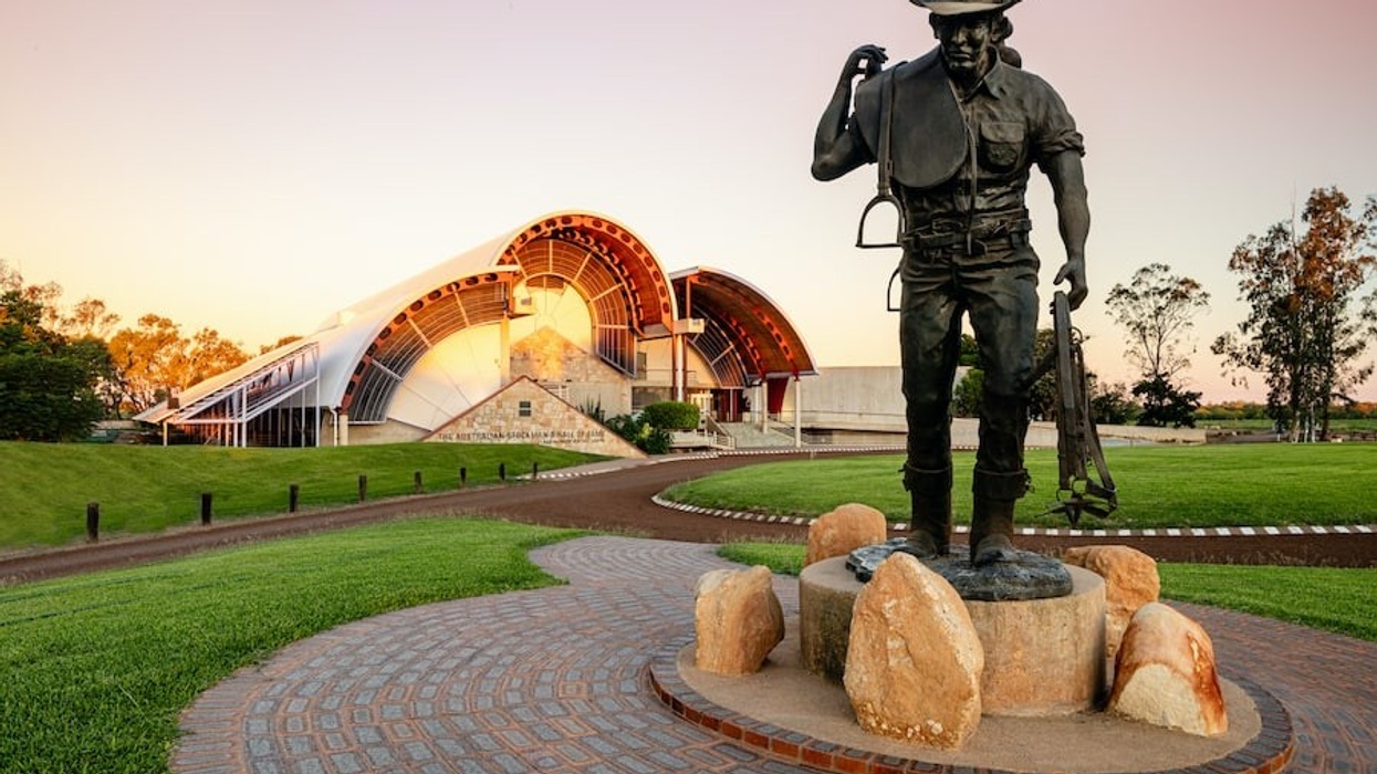 Large bronze statue of stockman outside museum building