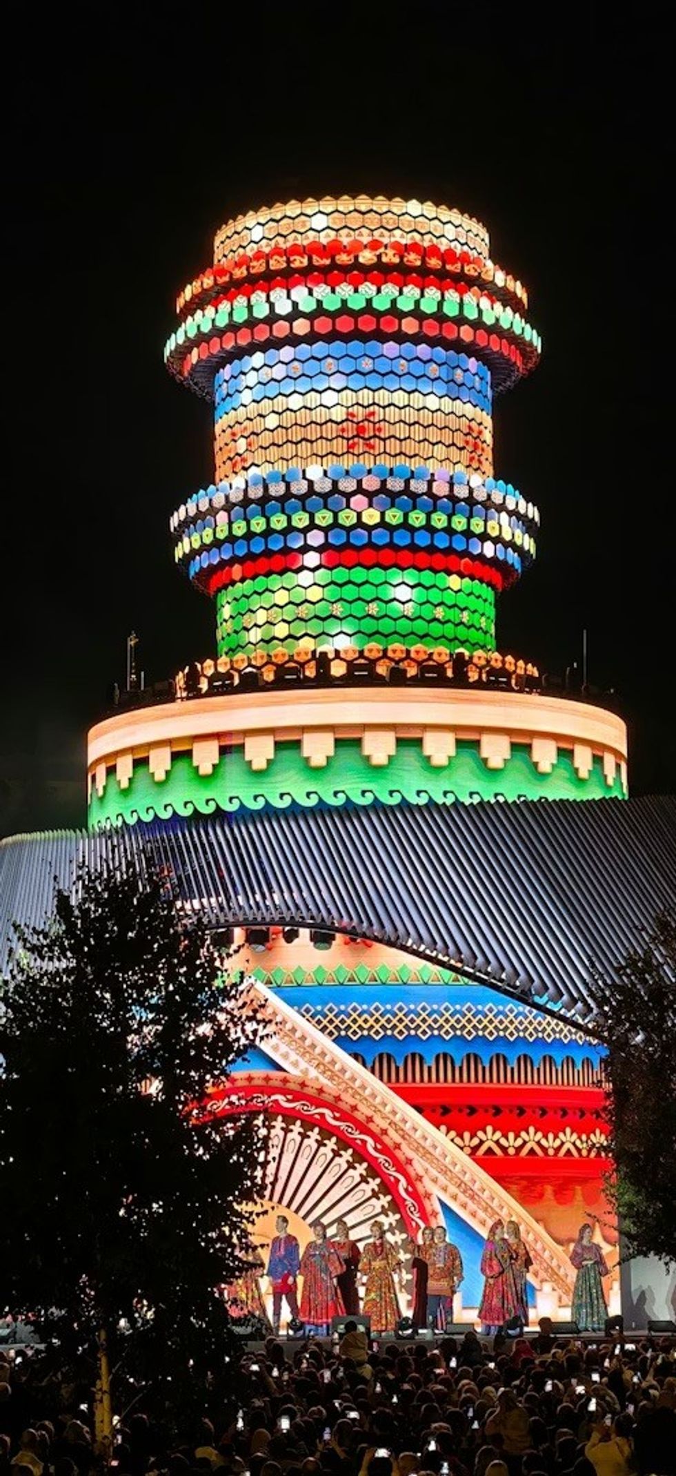 large crowd watching Media Matrexx \u2014 High-Tech Landmark of the Urban Core at night with performers on stage