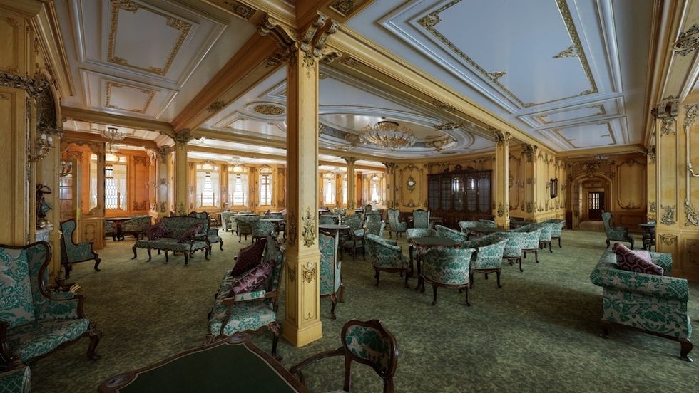 Lavish vintage lounge with ornate ceiling and green upholstered furniture.