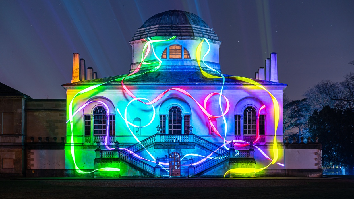 LCI - Chiswick House illuminated with vibrant, multicolored light projections at night.