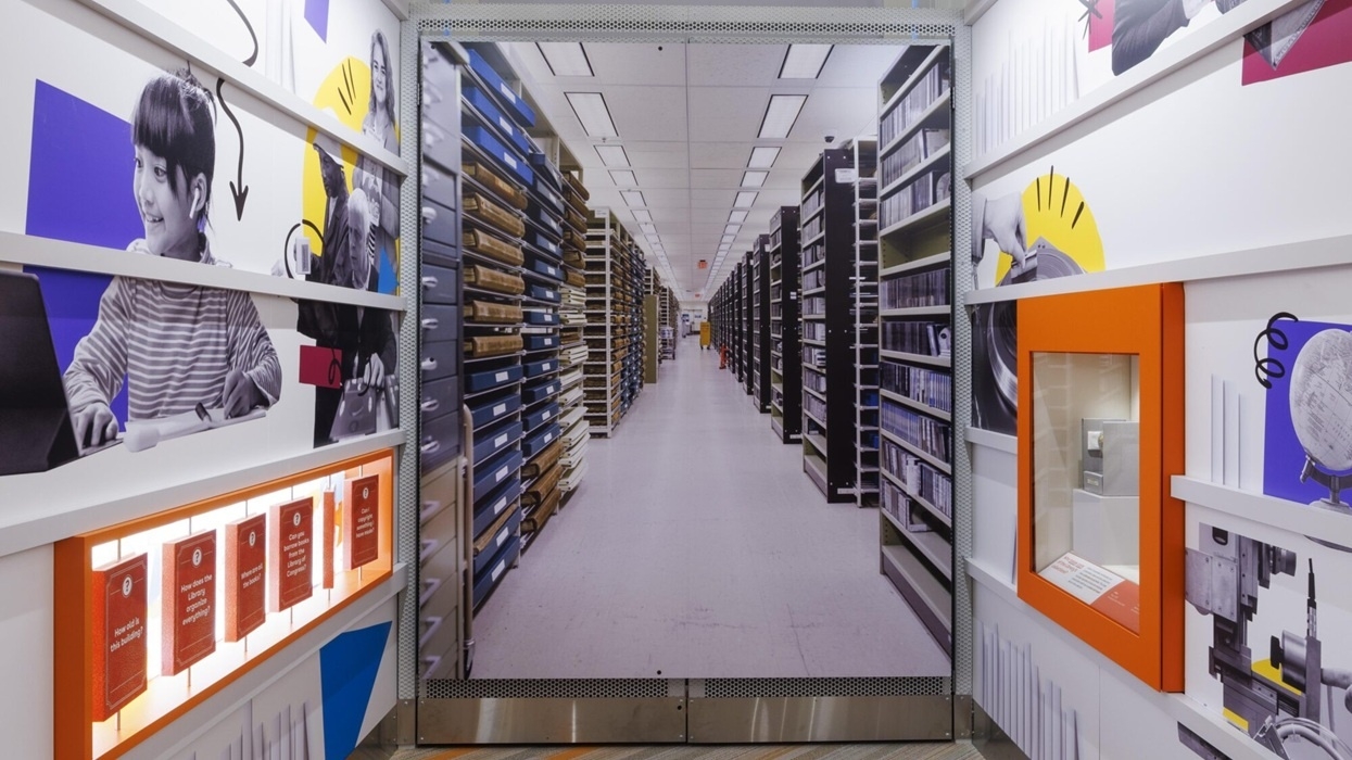 Library archive with colorful, educational-themed decor and long rows of shelves.