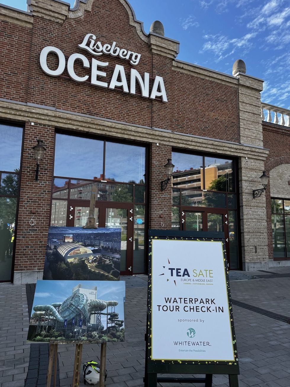 Liseberg Oceana entrance with waterpark tour check-in sign and posters outside.