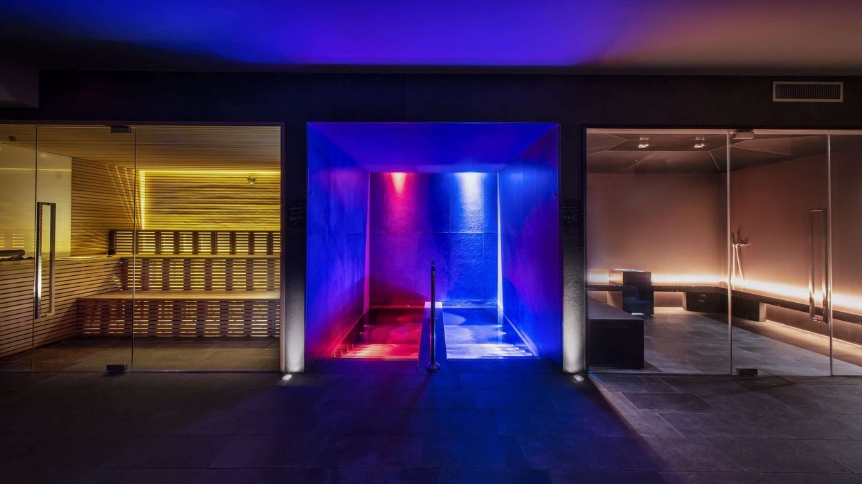 Lit spa rooms from Blue Mar Wellness with yellow, blue, and red ambient lighting.