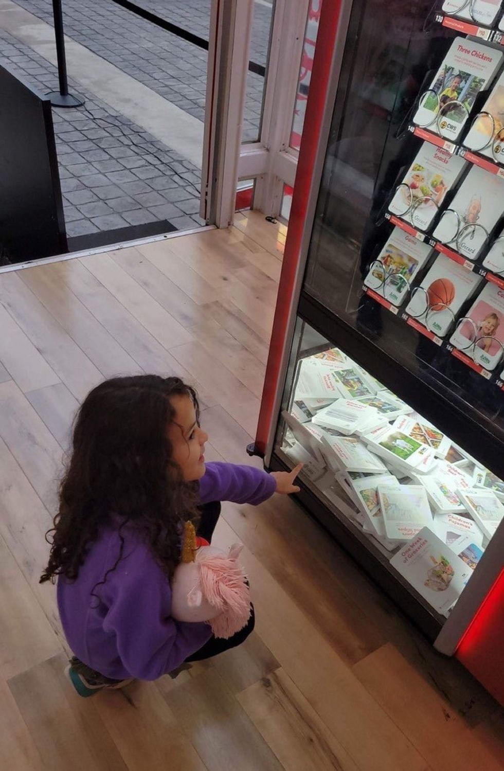 Little Girl Looking at Giving Machine Donations lessons from charity fundraising