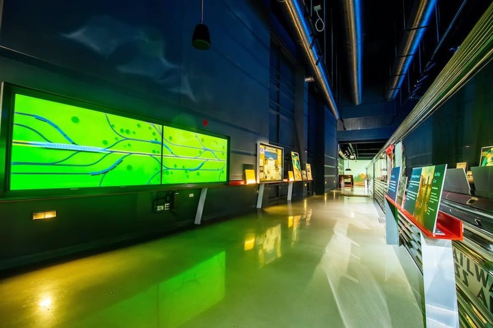 Long hallway with digital and analog museum displays
