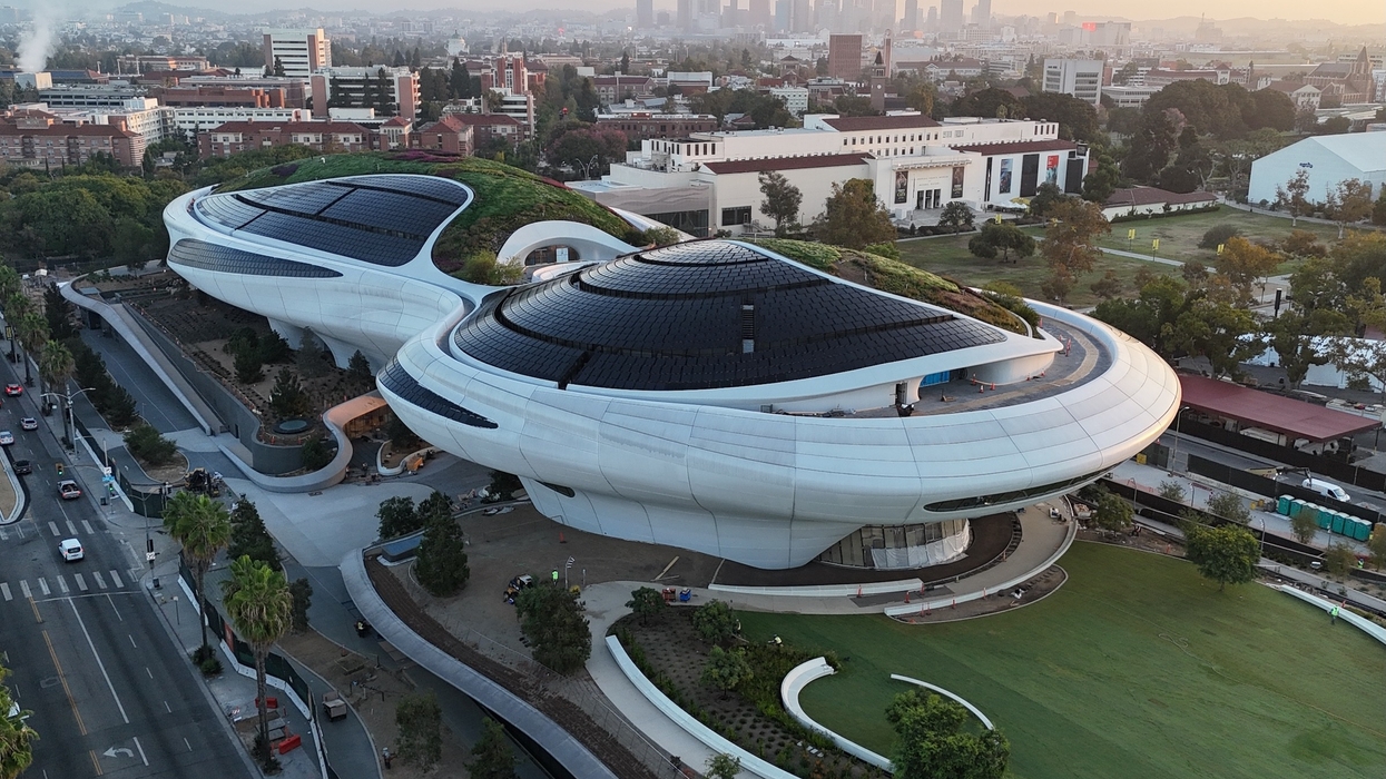Lucas Museum of Narrative Art opening 2026 - Futuristic building with curvy design and rooftop gardens in a cityscape at sunset.