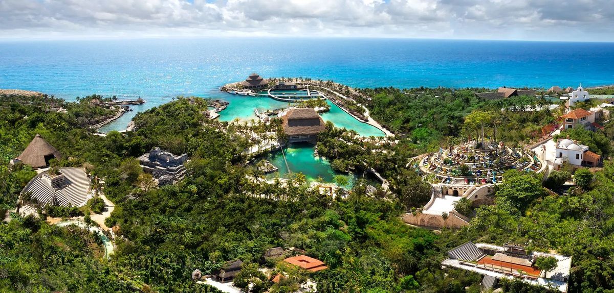 Lush coastal park called Xcaret with turquoise lagoons and vibrant tropical surroundings.