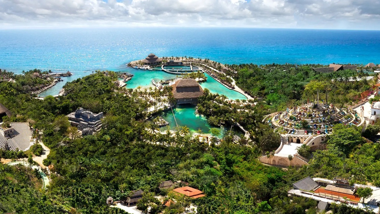 Lush coastal park called Xcaret with turquoise lagoons and vibrant tropical surroundings.