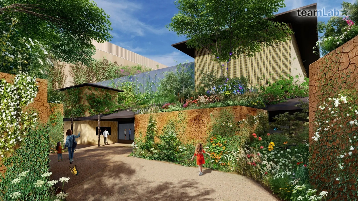 Lush garden path with people walking, surrounded by flowers and greenery at teamLab Tokyo