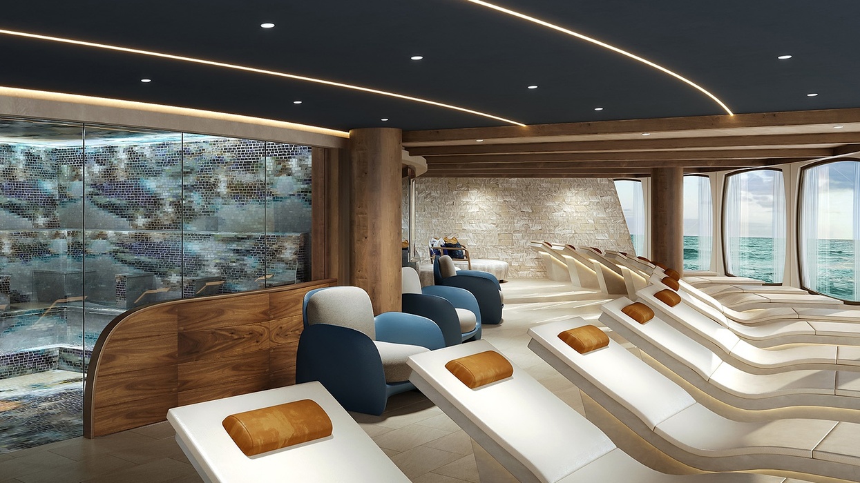 Luxurious spa relaxation area with loungers, ocean view, and mosaic wall on the Norwegian Aura