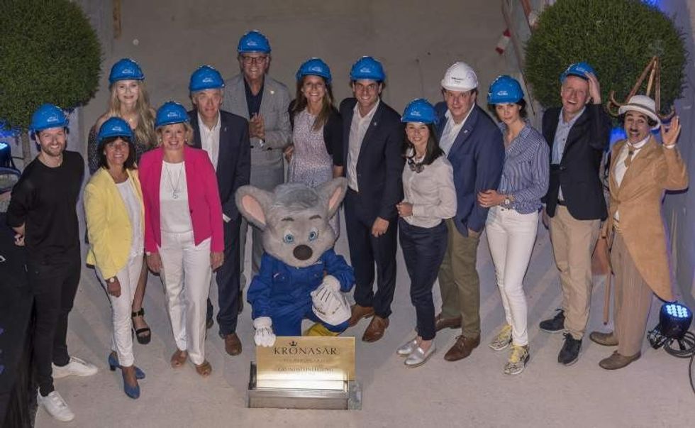 Mack family in hard hats at construction site of kronasar hotel