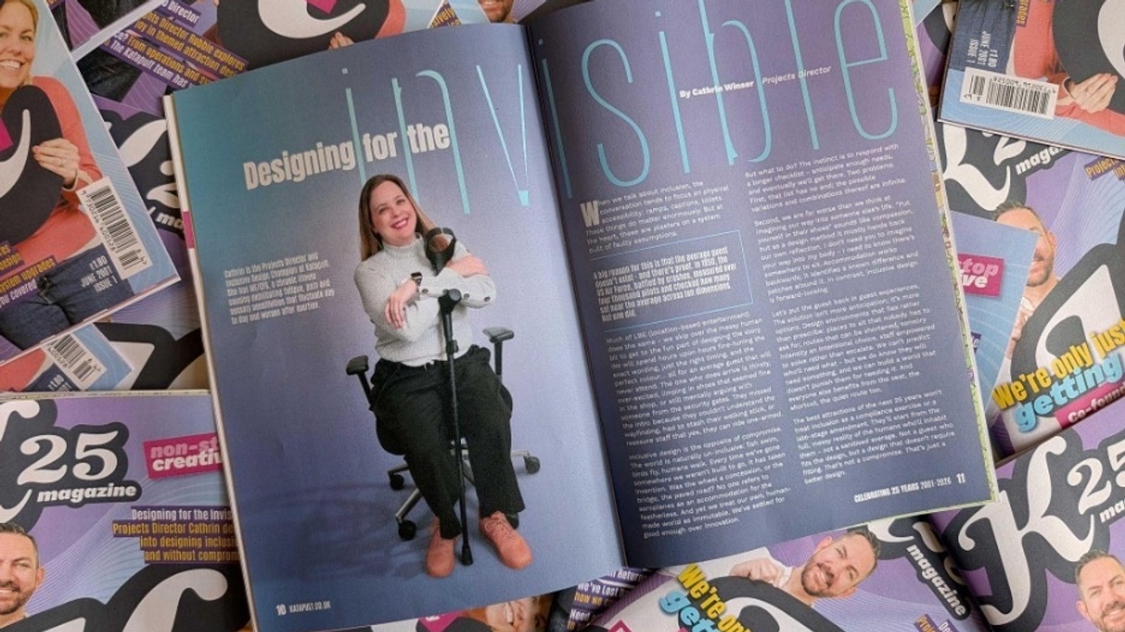 Magazine open to an article titled "Designing for the Invisible" amidst stacked copies.