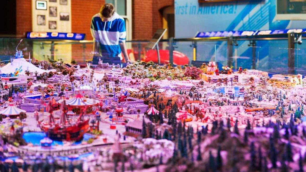 Male visitor looking at miniature layout of Disneyland