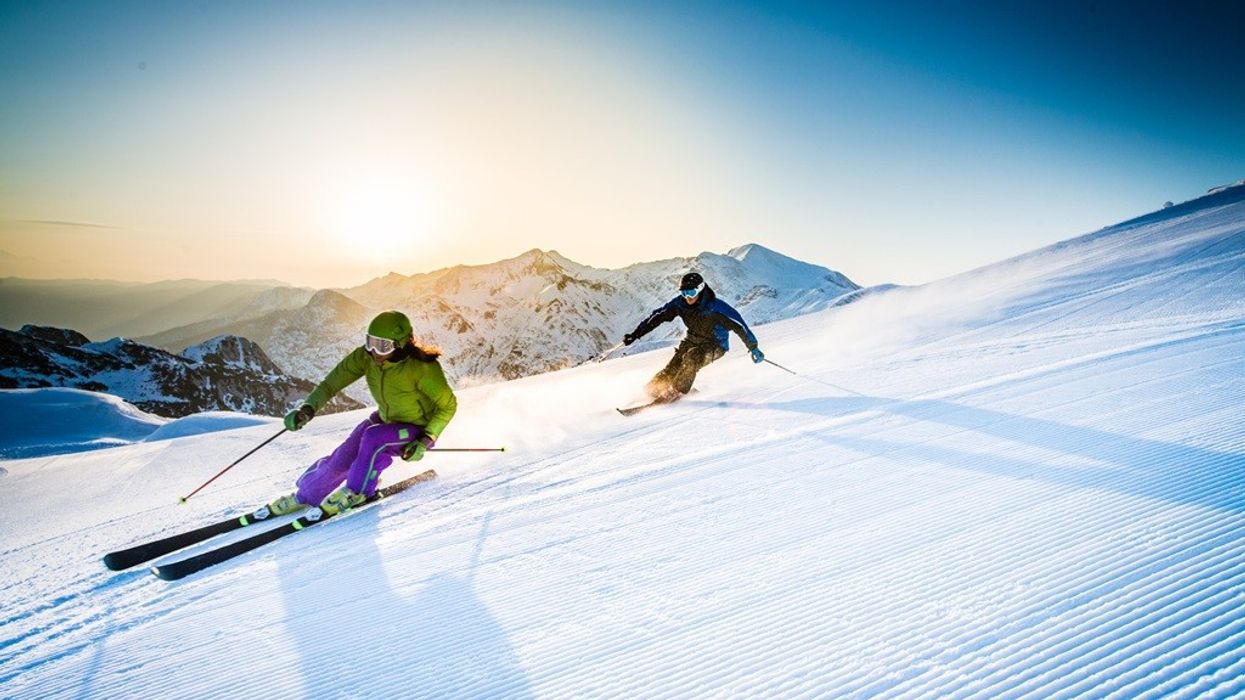 Man and woman skiing downhill