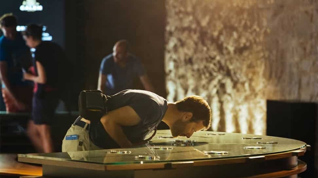 man looking inside glass case at Calem Cellars Port Experience