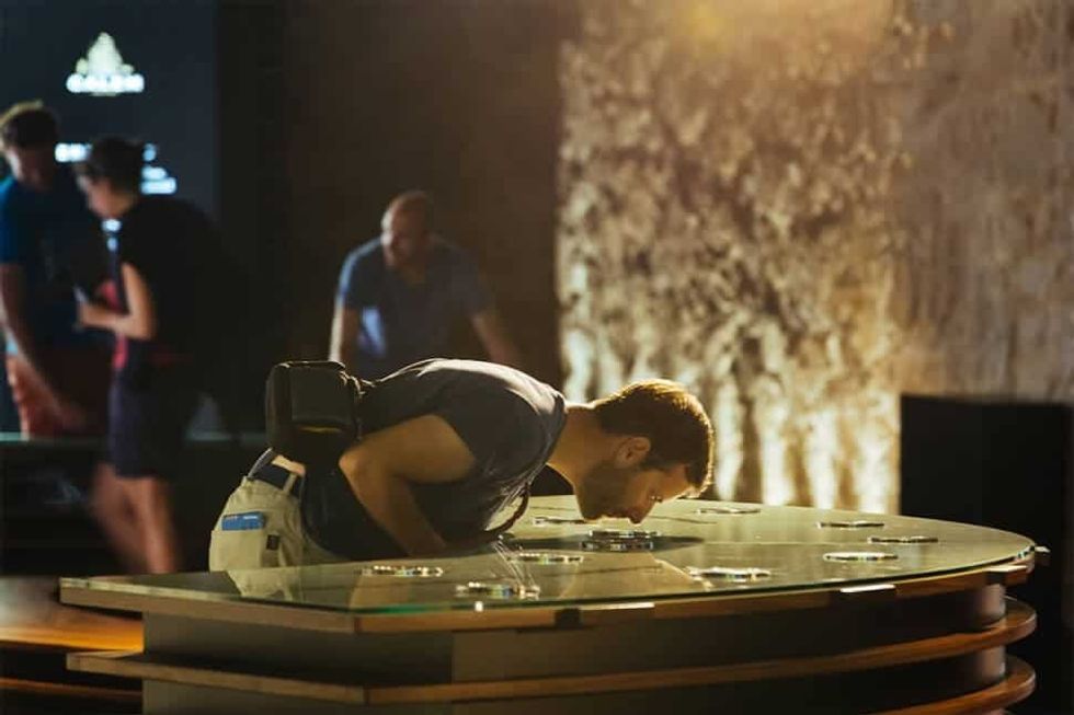 man looking inside glass case at Calem Cellars Port Experience