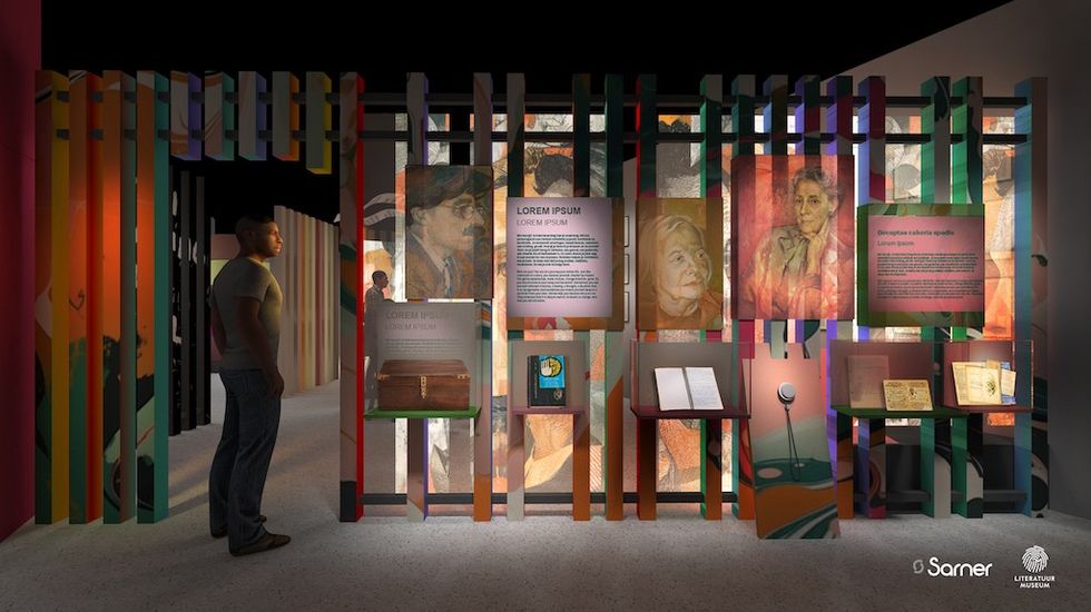 Man observing an illuminated museum exhibit with colorful panels and portraits.