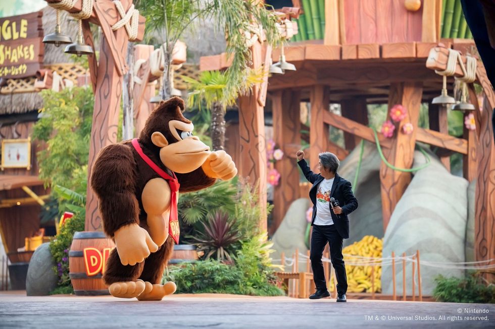 Man poses with Donkey Kong character at the Universal Studios Japan theme park.