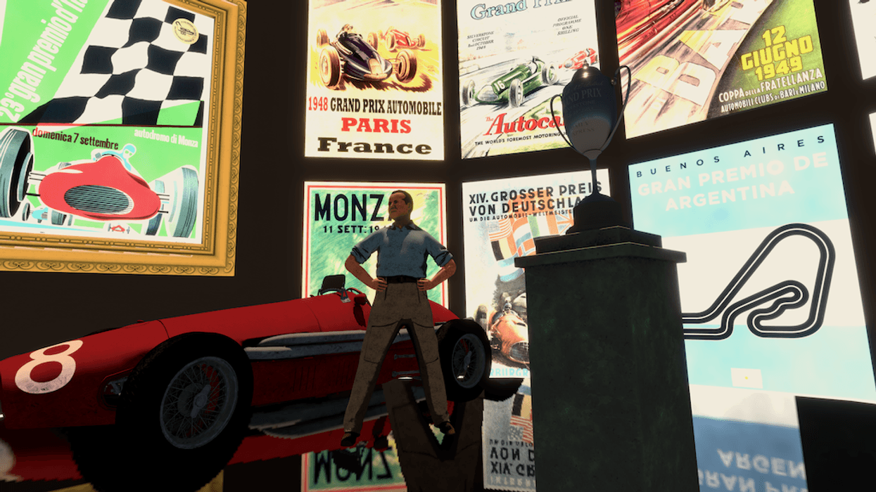 Man posing with vintage race car, surrounded by retro racing posters and a trophy.