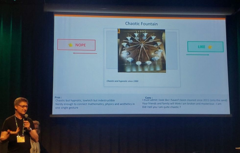 Man presenting a slide about the "Chaotic Fountain" with pros and cons.