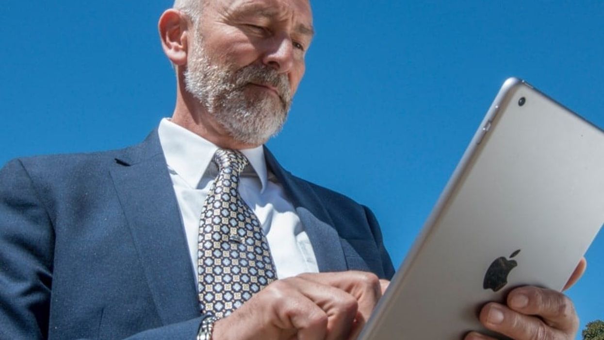 man uses Balboa park tour app by guru